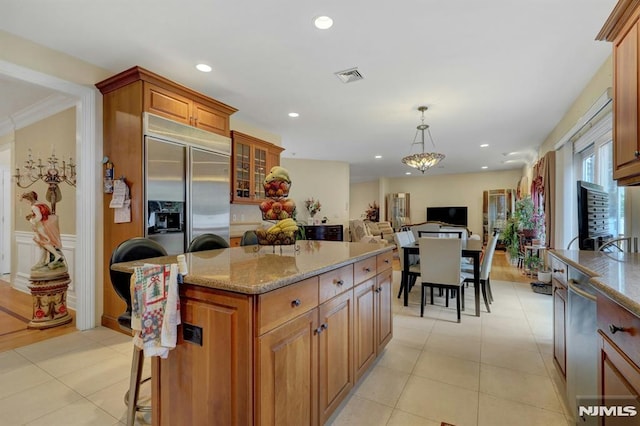 245 Forest Ave, Emerson, NJ 07630 - kitchen featuring stainless steel built in fridge, light stone countertops, open floor plan, a kitchen island, and brown cabinetry