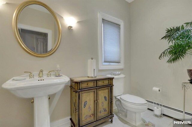 245 Forest Ave, Emerson, NJ 07630 - bathroom with a baseboard heating unit, toilet, and tile patterned floors