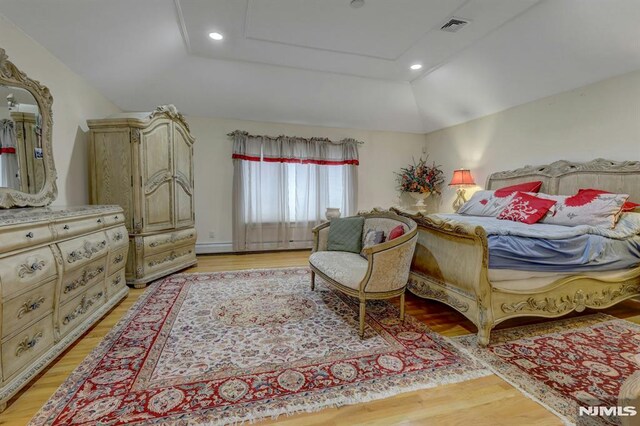 245 Forest Ave, Emerson, NJ 07630 - bedroom with light wood finished floors, vaulted ceiling, recessed lighting, and a raised ceiling