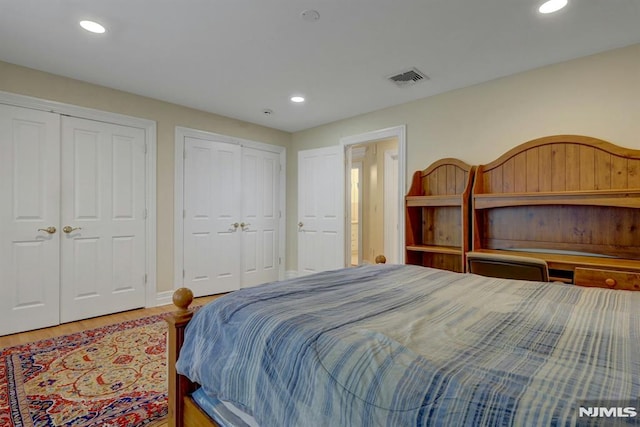 245 Forest Ave, Emerson, NJ 07630 - bedroom featuring two closets, recessed lighting, wood finished floors, and baseboards