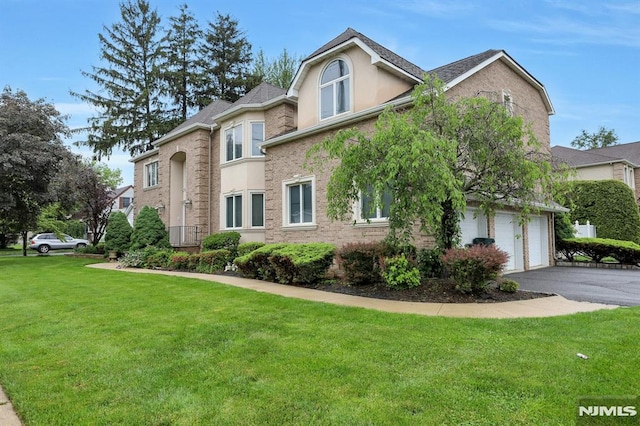 245 Forest Ave, Emerson, NJ 07630 - view of home's exterior featuring a lawn, an attached garage, asphalt driveway, stucco siding, and brick siding