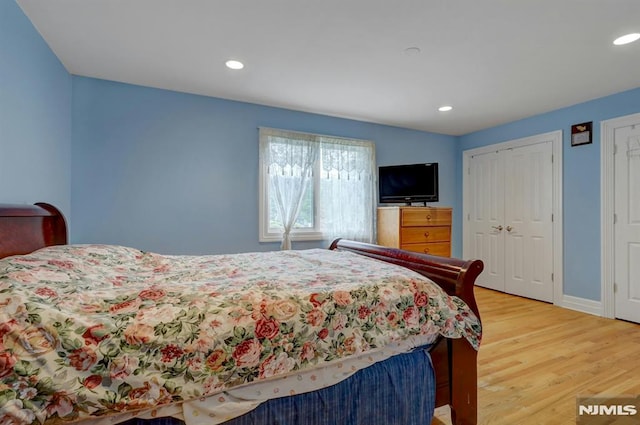 245 Forest Ave, Emerson, NJ 07630 - bedroom with light wood finished floors, recessed lighting, baseboards, and two closets