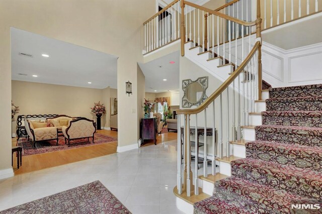 245 Forest Ave, Emerson, NJ 07630 - stairway featuring tile patterned flooring, baseboards, a high ceiling, and recessed lighting