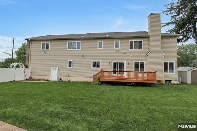 245 Forest Ave, Emerson, NJ 07630 - back of property with a chimney, a gate, and a wooden deck