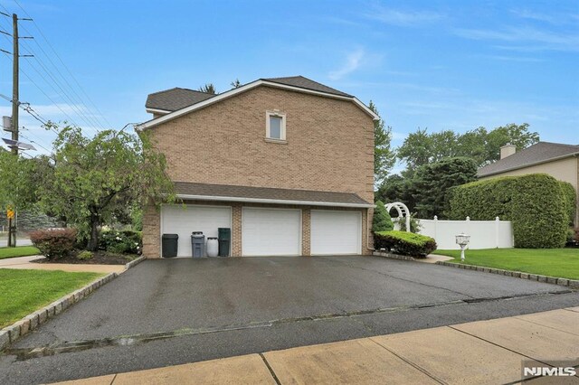 245 Forest Ave, Emerson, NJ 07630 - view of property exterior featuring an attached garage, driveway, and brick siding