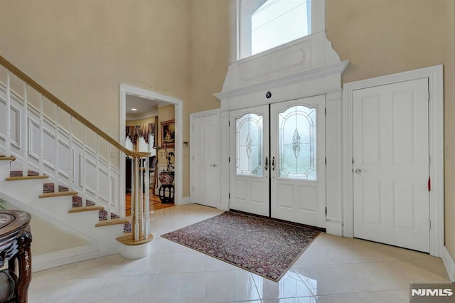 245 Forest Ave, Emerson, NJ 07630 - entrance foyer featuring a towering ceiling, stairway, tile patterned flooring, and baseboards