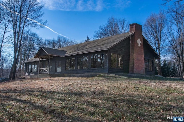 1 Brook Valley Ter, Kinnelon Borough, NJ 07405 - view of side of property featuring a chimney and a sunroom