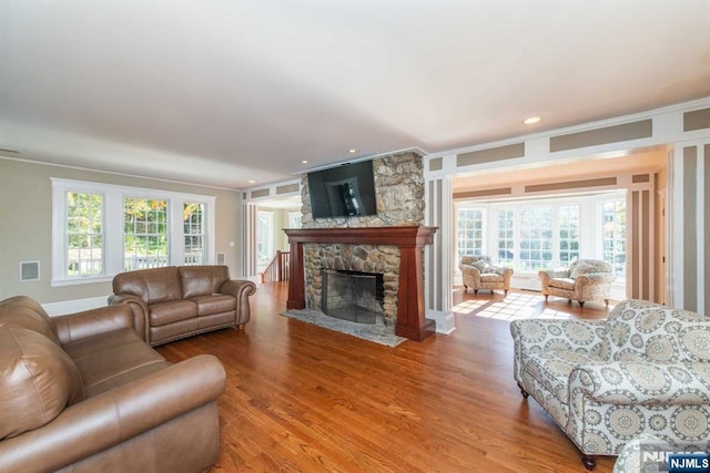 1 Brook Valley Ter, Kinnelon Borough, NJ 07405 - living room with ornamental molding, plenty of natural light, a fireplace, wood finished floors, and recessed lighting
