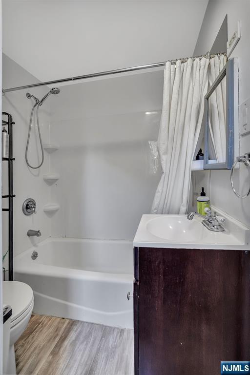 77 Myrtle Ave, Allendale, NJ 07401 - bathroom with vanity, toilet, shower / tub combo with curtain, and wood finished floors