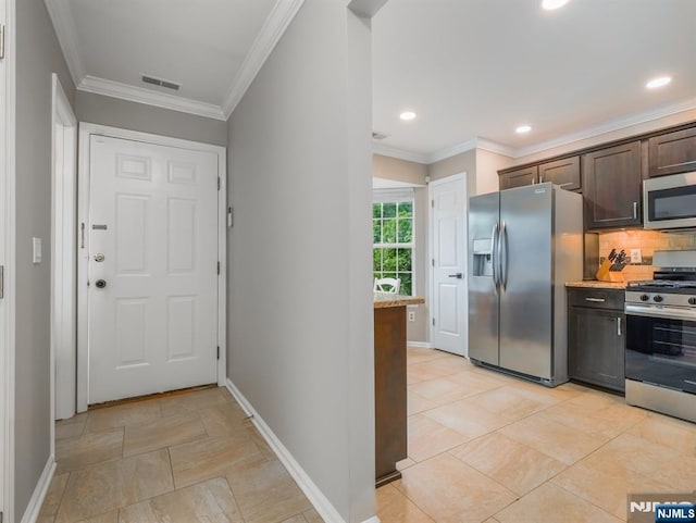3106 Tudor Dr, Pequannock Township, NJ 07444 - kitchen with stainless steel appliances, baseboards, dark brown cabinetry, backsplash, and ornamental molding