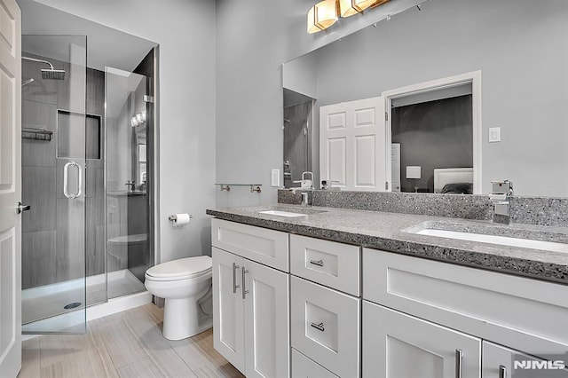 274 Roslyn Ct, West New York, NJ 07093 - bathroom with a shower stall, double vanity, and toilet