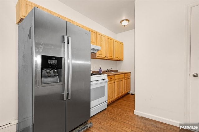 89 Westminster Pl, Garfield, NJ 07026 - kitchen with stainless steel fridge, gas range gas stove, under cabinet range hood, light wood-style floors, and light brown cabinetry