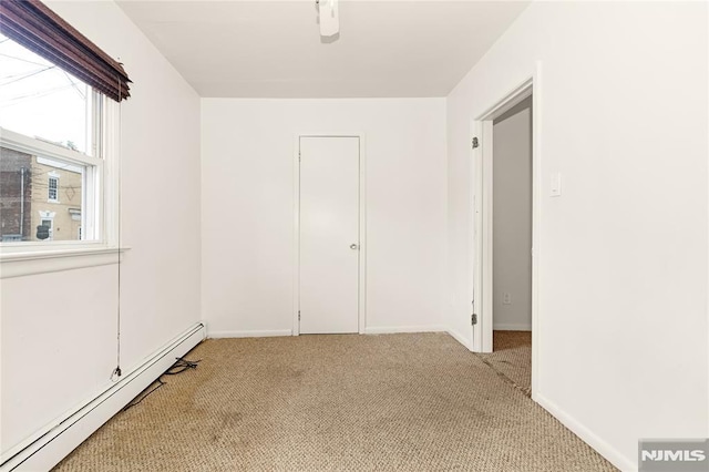 89 Westminster Pl, Garfield, NJ 07026 - unfurnished room featuring a baseboard radiator, light colored carpet, and baseboards