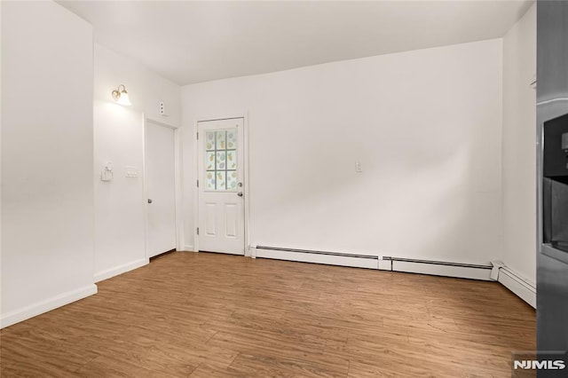 89 Westminster Pl, Garfield, NJ 07026 - spare room with a baseboard radiator, wood finished floors, and baseboards