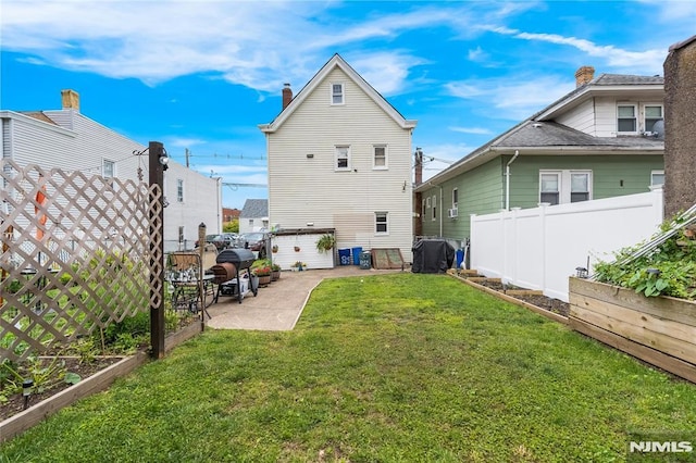 89 Westminster Pl, Garfield, NJ 07026 - back of property with a garden, a patio, and a chimney