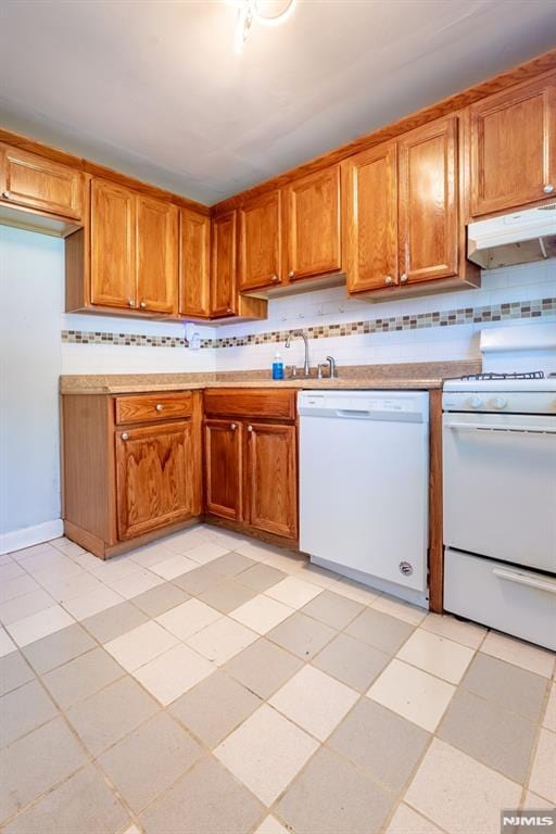 230 Lafayette Pl Unit 2B, Englewood, NJ 07631 - kitchen featuring white appliances, under cabinet range hood, decorative backsplash, and brown cabinets