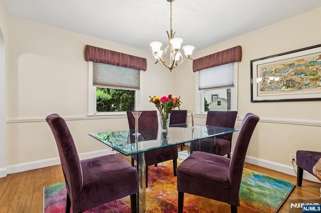 77 Bennett Rd, Teaneck, NJ 07666 - dining area featuring a chandelier, healthy amount of natural light, and baseboards