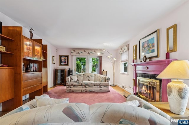 77 Bennett Rd, Teaneck, NJ 07666 - living area with a tile fireplace, baseboards, and wood finished floors