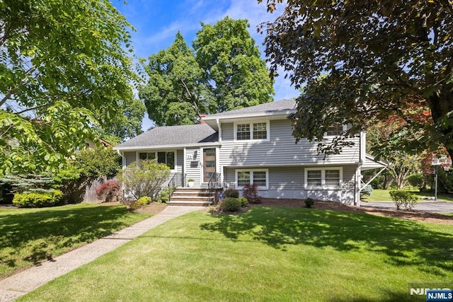26 Clover St, Tenafly, NJ 07670 - split level home featuring a front lawn and roof with shingles