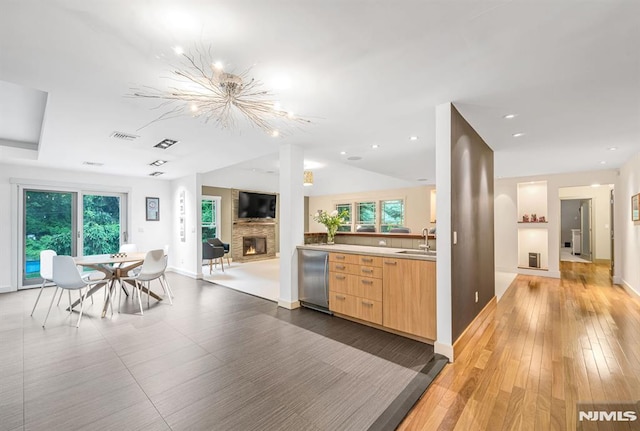 275 Gregory Rd, Franklin Lakes, NJ 07417 - kitchen with fridge, a sink, a fireplace, a chandelier, and healthy amount of natural light