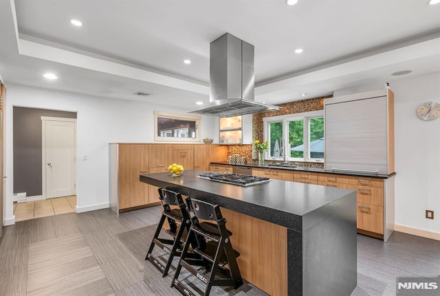 275 Gregory Rd, Franklin Lakes, NJ 07417 - kitchen with island exhaust hood, dark countertops, recessed lighting, backsplash, and stainless steel gas cooktop