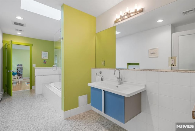 275 Gregory Rd, Franklin Lakes, NJ 07417 - bathroom with vanity, a tub, tile walls, a wainscoted wall, and recessed lighting