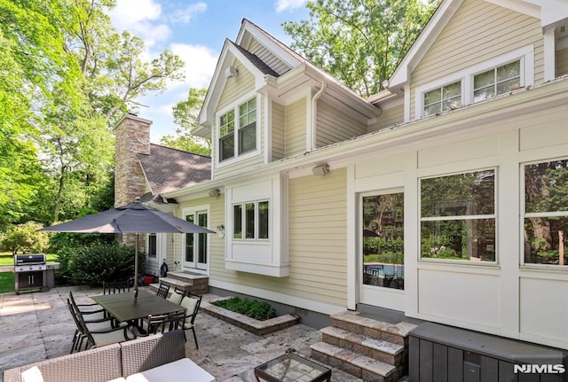 275 Gregory Rd, Franklin Lakes, NJ 07417 - back of property with entry steps, a patio, and outdoor dining area