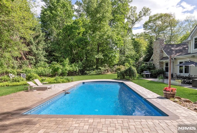 275 Gregory Rd, Franklin Lakes, NJ 07417 - outdoor pool featuring a patio area, a yard, a grill, and view of scattered trees