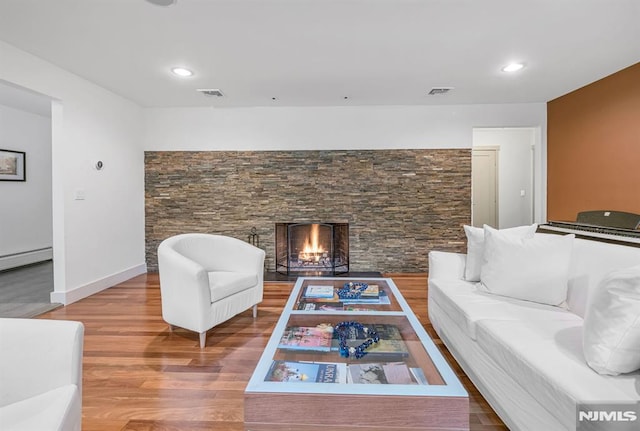 275 Gregory Rd, Franklin Lakes, NJ 07417 - living area with wood finished floors, a stone fireplace, a baseboard radiator, and recessed lighting