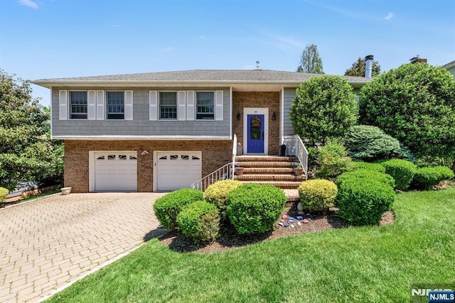 337 Vreeland Ave, Leonia, NJ 07605 - split foyer home with brick siding, decorative driveway, a garage, a front lawn, and entry steps