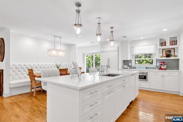 337 Vreeland Ave, Leonia, NJ 07605 - kitchen with a sink, light countertops, an island with sink, plenty of natural light, and recessed lighting