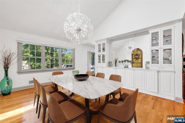 337 Vreeland Ave, Leonia, NJ 07605 - dining area with a chandelier, light wood finished floors, and high vaulted ceiling
