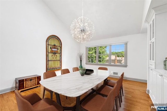 337 Vreeland Ave, Leonia, NJ 07605 - dining space with a chandelier, vaulted ceiling, light wood finished floors, and baseboards