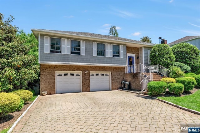 337 Vreeland Ave, Leonia, NJ 07605 - bi-level home with decorative driveway, brick siding, and an attached garage