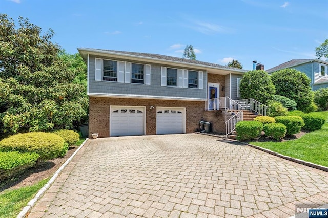 337 Vreeland Ave, Leonia, NJ 07605 - split foyer home featuring decorative driveway, brick siding, and an attached garage