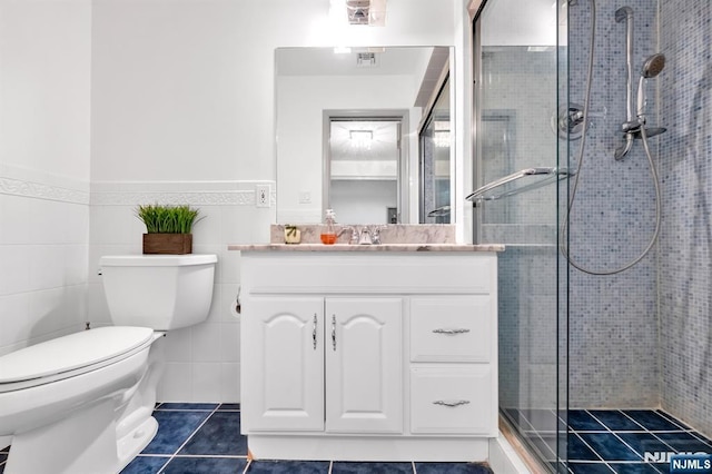 337 Vreeland Ave, Leonia, NJ 07605 - full bath with vanity, toilet, a shower stall, tile patterned floors, and a wainscoted wall