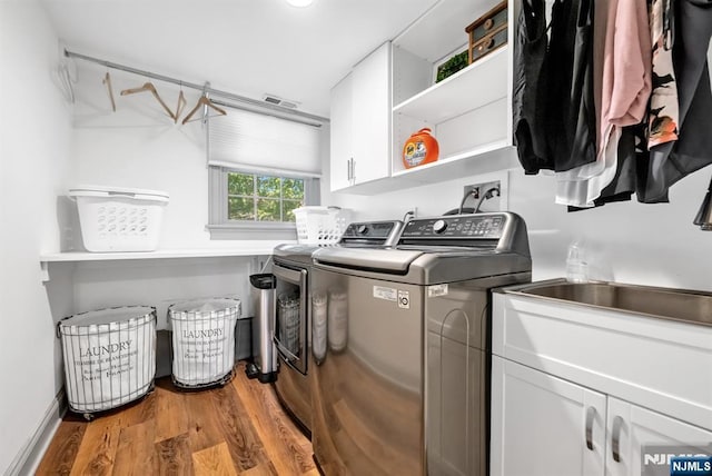 337 Vreeland Ave, Leonia, NJ 07605 - laundry room featuring cabinet space, washing machine and dryer, wood finished floors, and baseboards