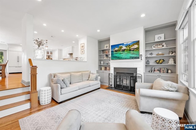 337 Vreeland Ave, Leonia, NJ 07605 - living room featuring light wood finished floors, a fireplace with flush hearth, recessed lighting, and built in shelves