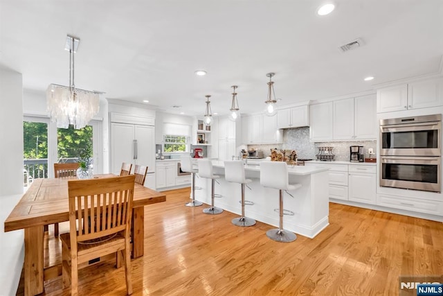 337 Vreeland Ave, Leonia, NJ 07605 - kitchen featuring stainless steel double oven, healthy amount of natural light, white cabinets, a chandelier, and recessed lighting