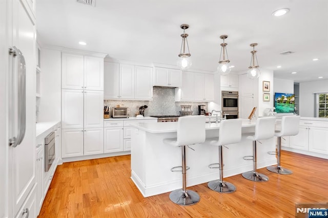 337 Vreeland Ave, Leonia, NJ 07605 - kitchen with appliances with stainless steel finishes, light countertops, decorative backsplash, white cabinets, and recessed lighting