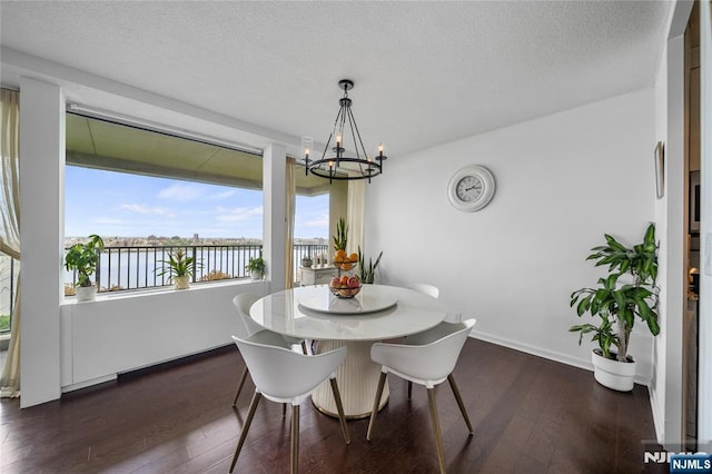 3 Horizon Unit 801, Fort Lee, NJ 07024 - dining area featuring a chandelier, a water view, dark wood-style flooring, a textured ceiling, and baseboards