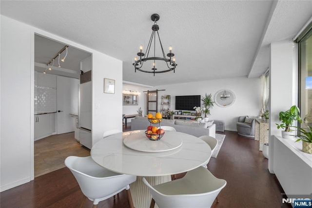 3 Horizon Unit 801, Fort Lee, NJ 07024 - dining area featuring wood finished floors, a chandelier, a textured ceiling, and baseboards
