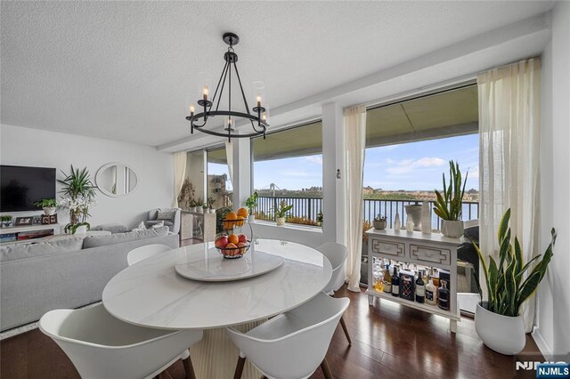 3 Horizon Unit 801, Fort Lee, NJ 07024 - dining area with a chandelier, wood finished floors, a textured ceiling, and a water view