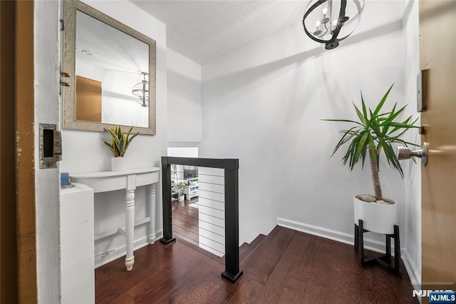3 Horizon Unit 801, Fort Lee, NJ 07024 - stairway with wood finished floors, a textured ceiling, a chandelier, and baseboards