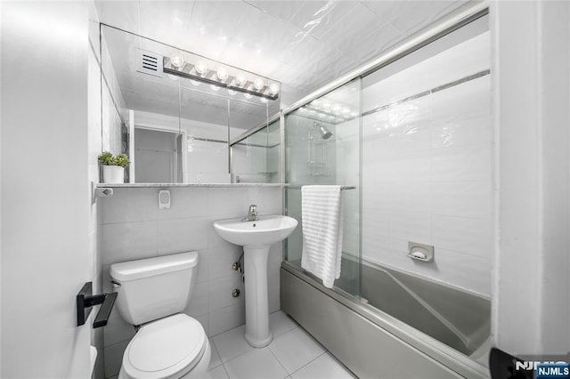 3 Horizon Unit 801, Fort Lee, NJ 07024 - full bath featuring bath / shower combo with glass door, toilet, tile walls, tile patterned flooring, and a sink