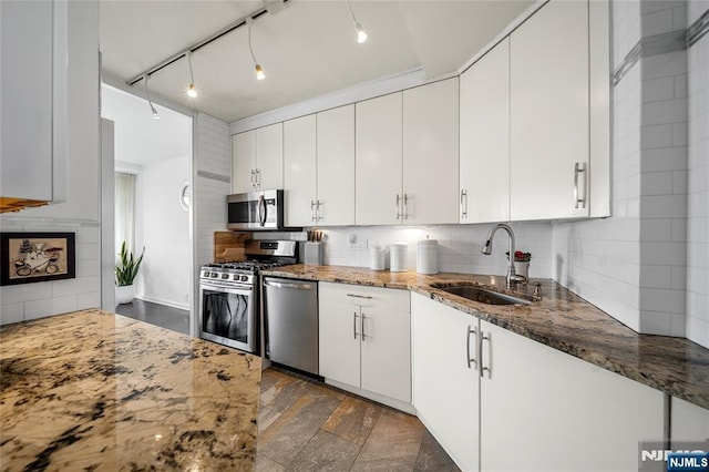 3 Horizon Unit 801, Fort Lee, NJ 07024 - kitchen featuring appliances with stainless steel finishes, a sink, backsplash, and stone counters