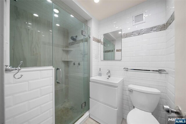 3 Horizon Unit 801, Fort Lee, NJ 07024 - full bath with tile walls, vanity, toilet, a shower stall, and recessed lighting