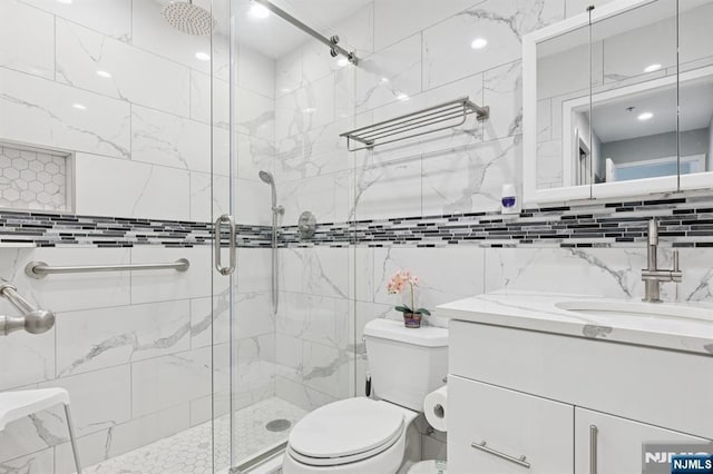 240 Main St Unit 211, Little Falls, NJ 07424 - bathroom featuring a stall shower, vanity, toilet, and tile walls