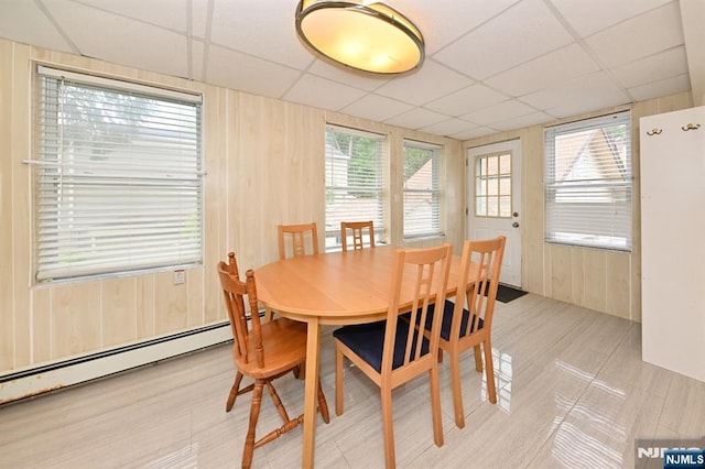 64 Rivervale Rd, Park Ridge, NJ 07656 - dining room featuring a drop ceiling, wood walls, and a baseboard heating unit