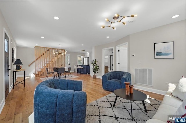 78 Schuyler Ave, North Arlington, NJ 07031 - living room with a chandelier, stairs, light wood-type flooring, baseboards, and recessed lighting